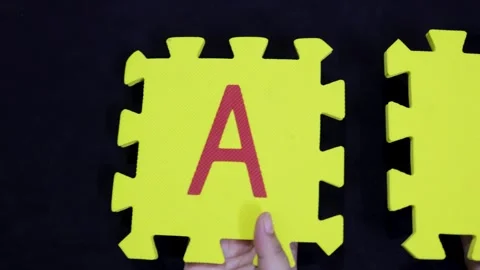 Innovation and machine learning concept foam jigsaw letters a and i held up in Stock Footage 319071050