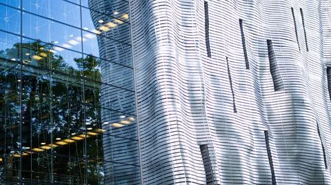 An Innovative Architectural Facade that features Reflective Glass and intriguing Stock Photos