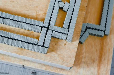 Innovative cardboard box design process featuring precision die cutting tools on Stock Photos