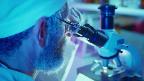Innovative Chemist Analyzing Samples in High-Tech Laboratory With Neon Lighting Stock Footage 283523827