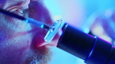 Innovative Chemist Analyzing Samples in a Purple Neon Research Laboratory Stock Footage 282507679