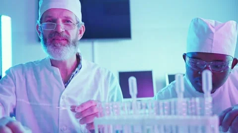 Innovative Chemists Analyzing Experiments in Neon Lit Laboratory 스톡 동영상 282506792