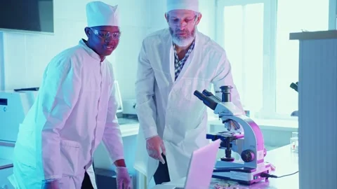 Innovative Chemists Analyzing Samples in Modern Laboratory With Advanced Stock Footage 282507832
