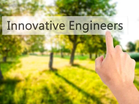 Innovative Engineers - Hand pressing a button on blurred background concept . Foto stock