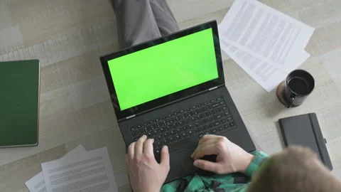 Innovative freelancer working and using laptop with green screen from home Stock Footage 142750274
