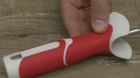 This is an Innovative Kitchen Tool that features a Red and White Handle for easy Stockbeeldmateriaal 281328032