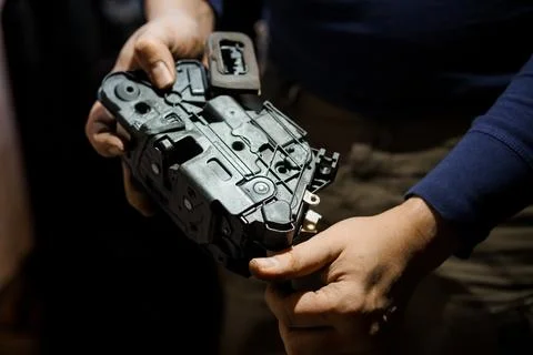 Innovative Mechanical Component: Close-Up of a Hand Holding a Black Plastic.. Stock Photos