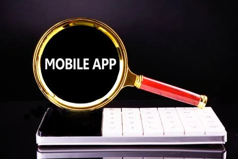Innovative mobile app development showcased with a magnifying glass over a .. Stock Photos