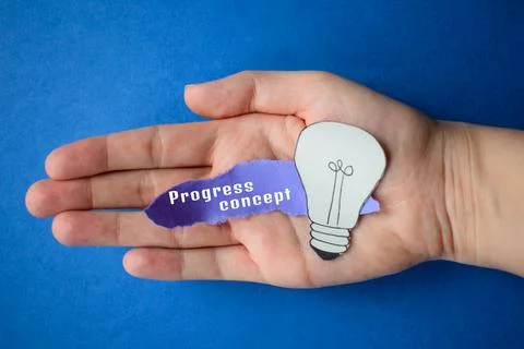 Innovative Progress Concept with Lightbulb Held in Palm Foto stock