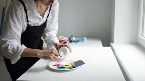 Innovative real artist using white paint and palette knife on big canvas. Stock Footage 197816914