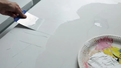 Innovative real artist using white paint and palette knife on big canvas. Stock Footage 197817006