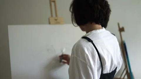 Innovative real female painter using palette knife on big canvas. Stock Footage 197816778