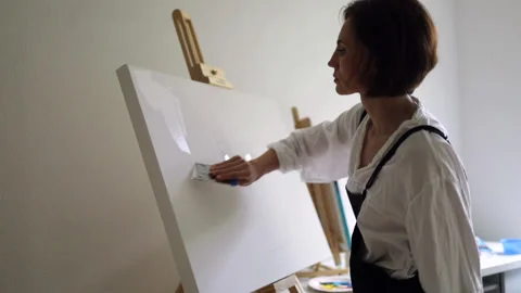 Innovative real female painter using palette knife on big canvas. Stock Footage 197816843