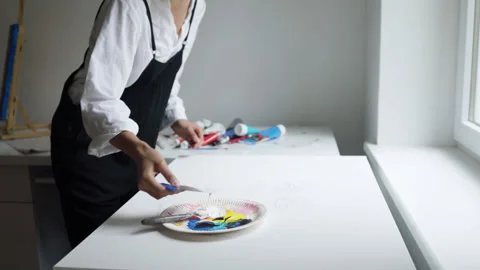 Innovative real female painter using palette knife on big canvas. Stock Footage 197816916