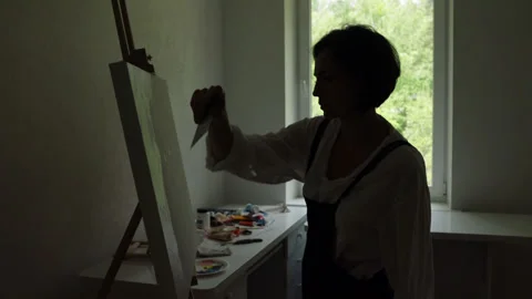 Innovative real female painter using palette knife on big canvas. Stock Footage 197816994