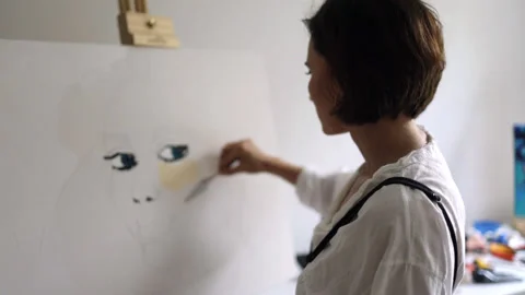 Innovative real female painter using palette knife on big canvas. Stock Footage 197817038