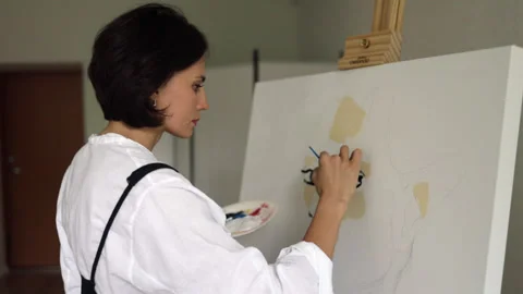 Innovative real female painter using palette knife on big canvas. Stock Footage 197817081