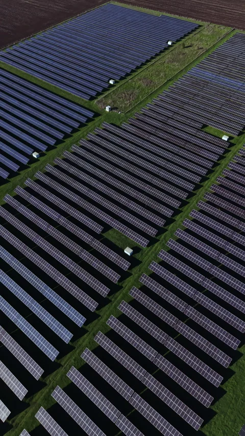 Innovative solar panel farm harnessing clean energy in a sunny, rural landscape Stock Footage 335402017