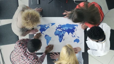 Innovative team discussing the world map in the office Stock Footage 73848702