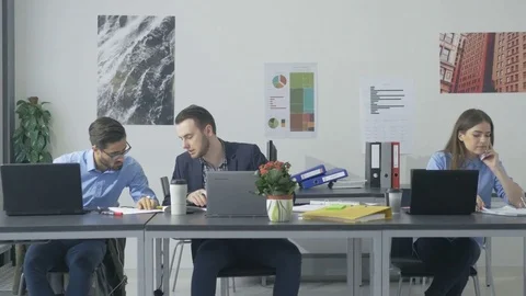 Innovative team working on the project while sitting in the bright modern office 스톡 동영상 73990743