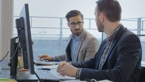 Innovative team working on the project while sitting in the bright modern office Stock Footage 73991556