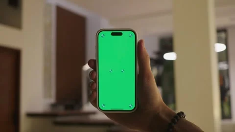 Innovative uses of green screen technology hand holding smartphone with green Stock Footage 312505573