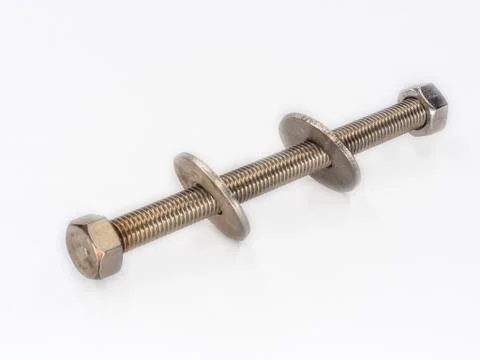 Inox nut welded to thread rod with wide washer shot on white. Stock Photos