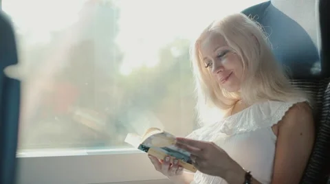 Inquisitive blonde reading a book Stock Footage 59799813