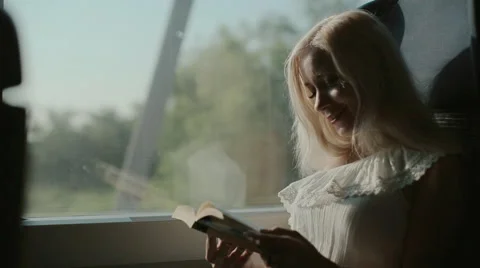 Inquisitive blonde reading a book Stock Footage 59800129