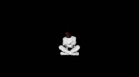 Аn insane black man in his forties wearing a straitjacket sitting in a dark of Video stock 59088249