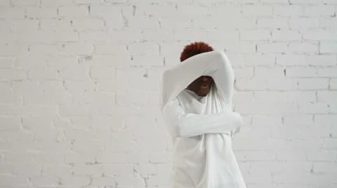An insane black man in his forties wearing a straitjacket dance and try to get Stock Footage 59089592