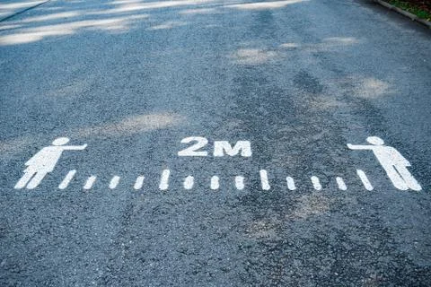 Inscription on the asphalt, to keep distance. Stock Photos