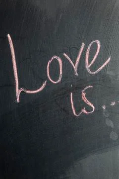 The inscription on the chalk board Love is. Valentine's Day Stock Photos