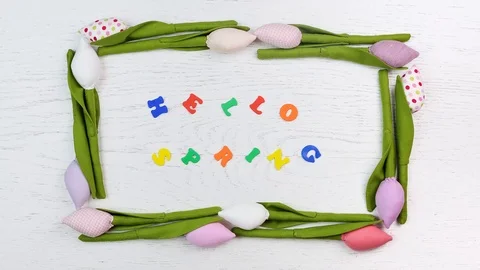 An inscription in colored letters "hello spring" inside the animated frame of 库存影片 85948775