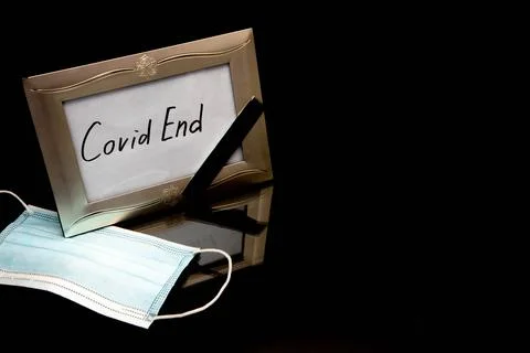 Inscription Covid end on a white background in y photo frame Stock Photos