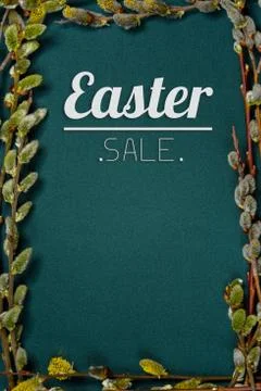 The inscription "Easter" on a green background surrounded by branches of will 写真素材