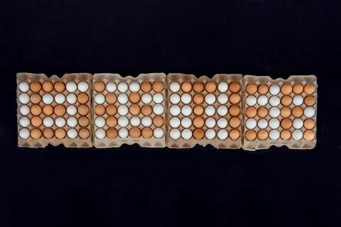 The inscription EASTER is lined with brown eggs top view. Hundreds of white e Stock Photos