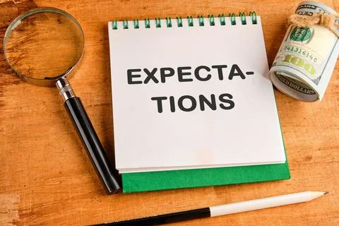 Inscription Expectations word in a notebook in a composition with a magnifyin Stock Photos
