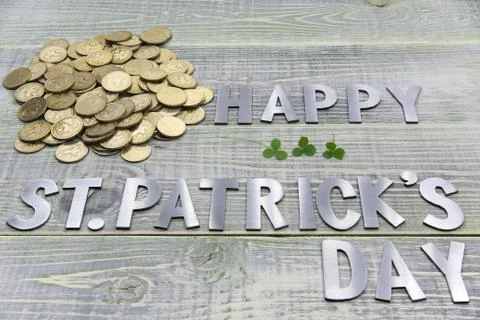 Inscription happy Patricks day, a lot of gold British coins and three sheets of Stock Photos