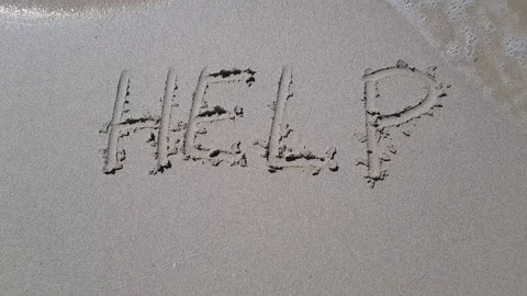 Inscription help on a sandy beach washed by sea waves Stock Footage 220507552