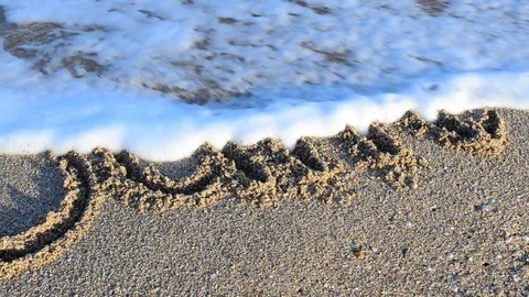 Inscription June on sand. The inscription is washed away by a sea wave. Stock Footage