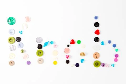 Inscription Knob made of tailor's knobs of many sizes shapes and colors - on 库存照片