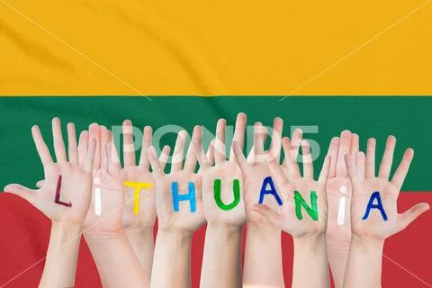 Inscription Lithuania on the children's hands against the background of a wav Stock Photos