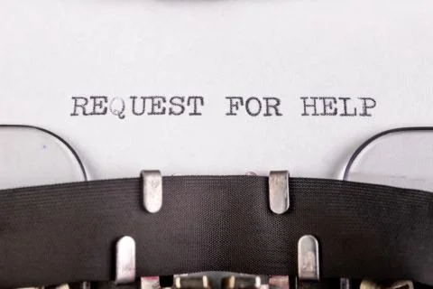The inscription "request for help" on a white sheet of paper in an old typewr Stock Photos