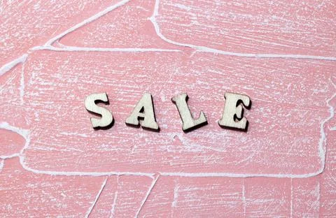Inscription sale of plastic white blocks on a pink background for an advertis Stock Photos