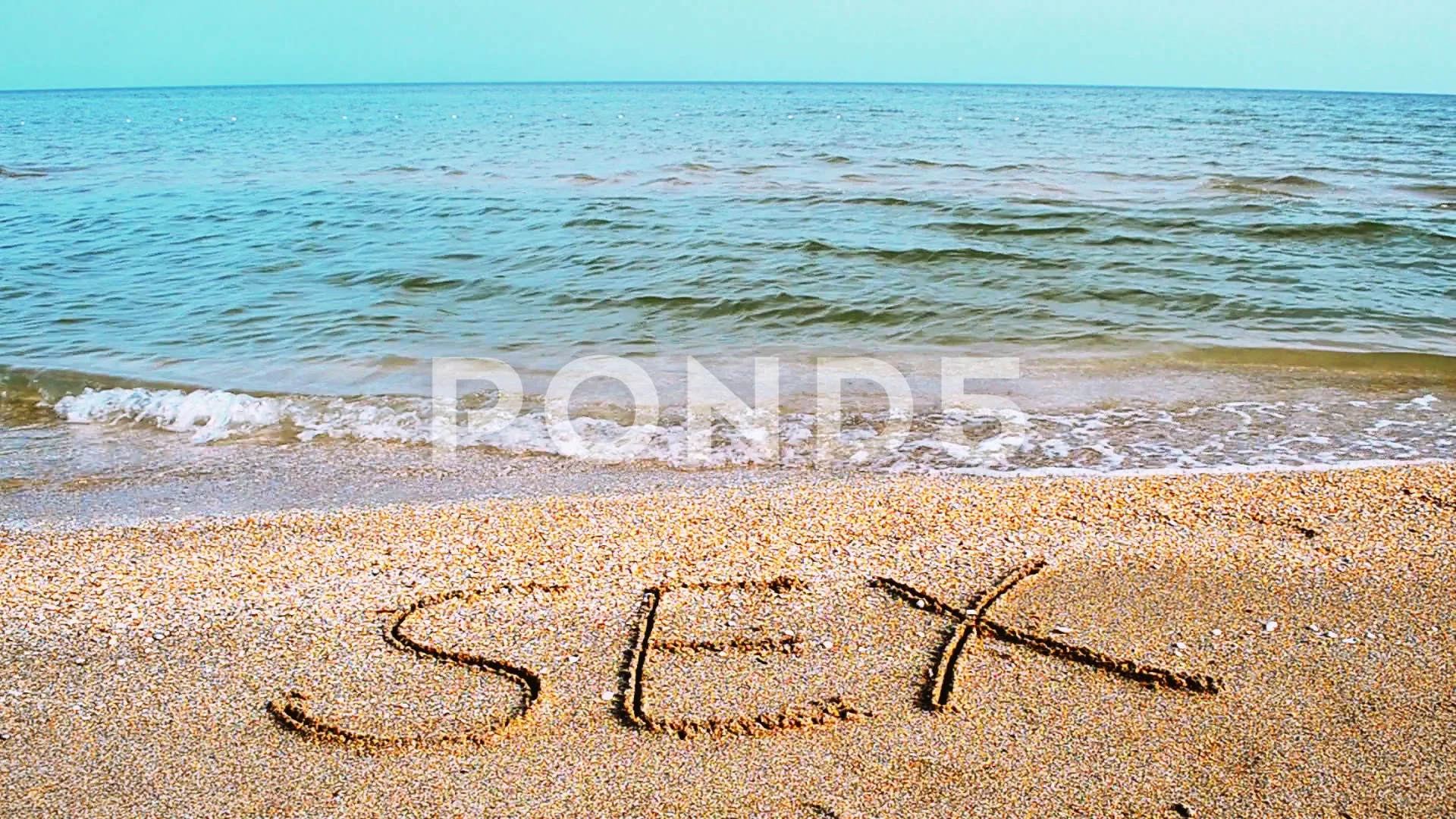 Inscription on sand sex. An inscription on the beach.