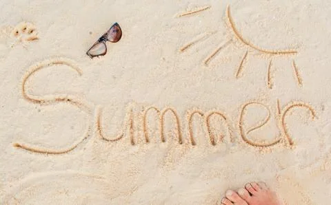 The inscription on the sand of the stones "summer". Summer lettering on the b Stock Photos