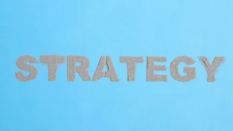 Inscription "strategy" from sand appears on the blue screen Stock Footage 81471237