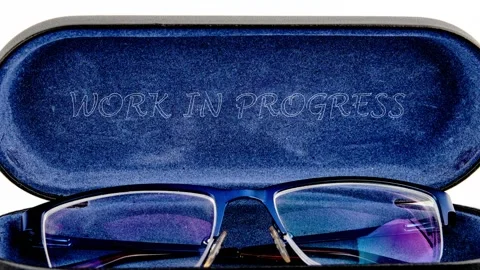 The inscription WORK IN PROGRESS on the inner lining of a blue velvet eyeglass Stock Footage 332977689