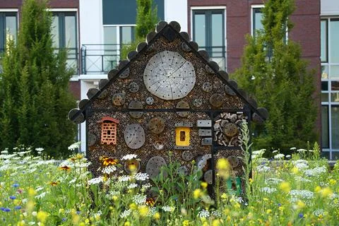An insect hotel to support wild bees and other beneficial insects in parks .. Stock Photos